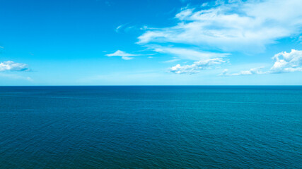 Obraz premium Nature of the beach and sea Summer with sunshine, sandy beaches, clear blue waters sparkling against the blue sky. On an island with good ecology and environment Background for summer vacation concept