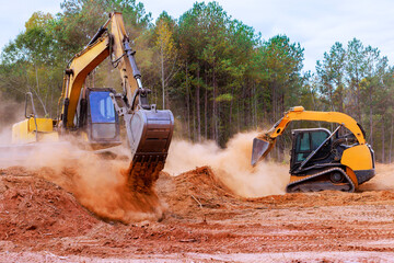 During earthmoving on construction site, bulldozer is leveling ground in preparation for grading...