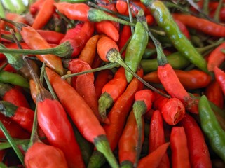 A Spicy Bunch of Red and Green Chilis, aku A close up of  chili peppers and some green ones.