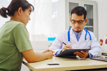 Fototapeta premium A male doctor sits at a desk in a hospital,reviewing a female patient’s medical history.He provides compassionate advice for depression, addressing symptoms like sadness,hopelessness, anger, anxiety
