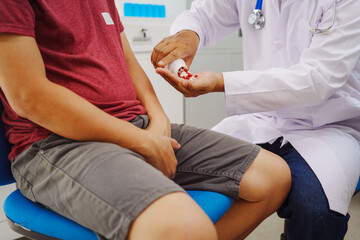 A man consults a doctor in a hospital for a male urinary tract infection. The doctor advises on...