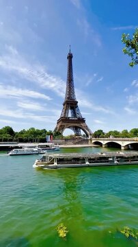 Spectacular View of Eiffel Tower From The River Seine
Breathtaking view of the Eiffel Tower standing gracefully against a clear blue sky, reflected in the tranquil waters of the River Sei