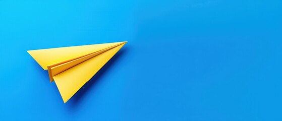 A vibrant yellow paper airplane on a bright blue background, symbolizing creativity and childhood fun.