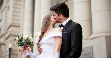 Wedding, kiss and couple in city for love at marriage ceremony, celebration and event. Romance,...