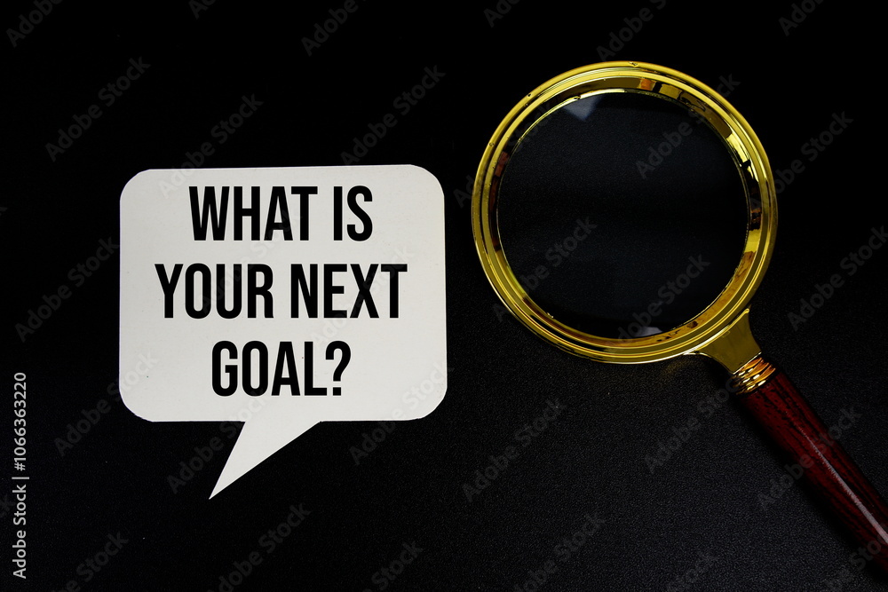 Poster what is your next goal? text on speech bubble with magnifying glass top view on black background