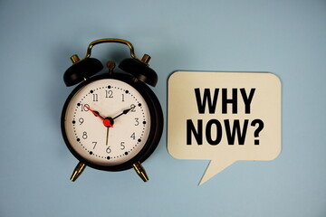 Why now? text on speech bubble with alarm clock top view on blue background