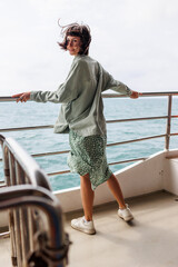 Woman on vacation on a cruise ship during summer travel. Silhouette of a tourist relaxing on the...