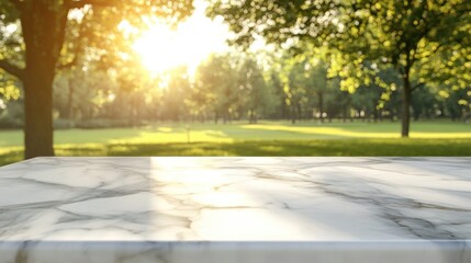 Fototapeta premium Shiny marble table top illuminated by sunlight against a softly blurred park backdrop ideal for showcasing products