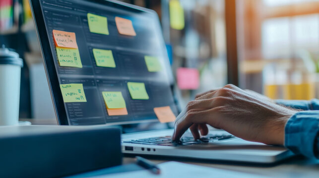 A business developer uses a Kanban board on their laptop to manage projects. This helps them to organize and track their work efficiently, following an agile approach.