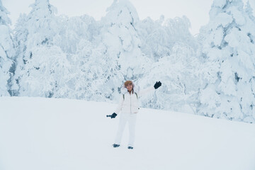 Woman tourist sightseeing Snow monster in Winter day at Mount Zao, Yamagata prefecture, Japan. Happy Traveler walking on powder snow covered in frosty weather. Travel, Adventure and Vacation