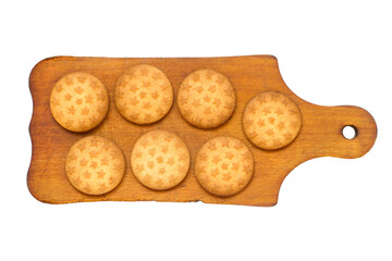 Round biscuits on a wooden cutting board. Cutting board with cookies on a white background.