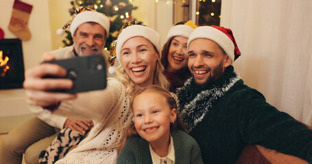 Christmas, happy and selfie of family and child in home take photo for profile picture, social media and memory. Grandparents, smile and mom, dad and girl for festive tradition, holiday and vacation