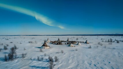 Nenets camp under bright northern lights in snowy tundra. Reindeer graze near teepees, showing traditional nomadic lifestyle, deep connection to Arctic nature, and cultural heritage.