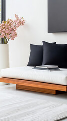 Modern minimalist living room with a sleek sofa, decorative pillows, and a floral arrangement