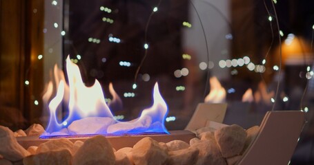 Christmas decorations with biofire create magical holiday atmosphere. warmth of flames paired with...