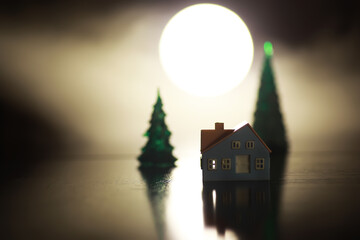 Miniature House and Trees with Full Moon Background: Nighttime Serenity