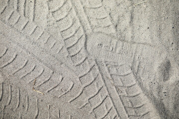 Tire Tracks and Shoeprint in Sand Showing Outdoor Activity and Patterns
