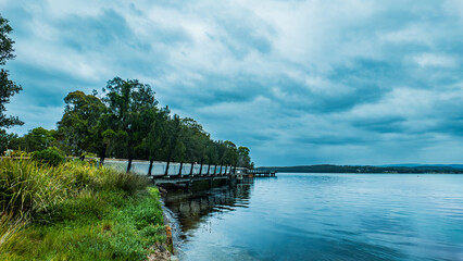 Fototapeta premium The Red Bluff Boardwalk in Booragul, NSW is a popular attraction that offers shared walking and bicycle pathways