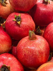 Close-up of fresh pomegranates. Background image of ripe pomegranates.