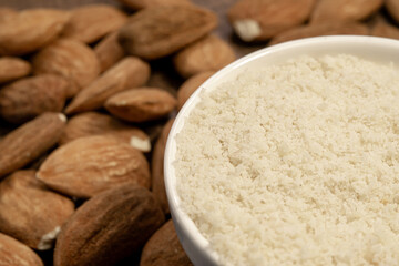 raw almond nuts and almound flour close up