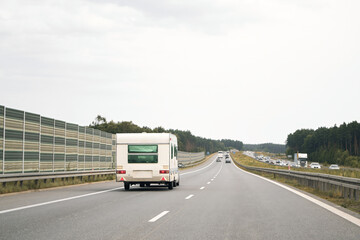 Classic camper van exploring rural highway near park