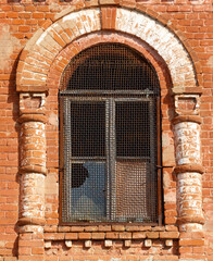 A window with a metal frame and a hole in it