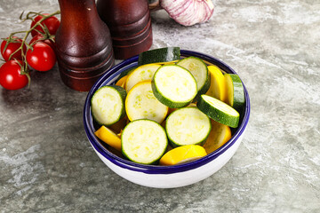 Sliced raw young green and yellow zucchini