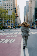 Woman walking in urban city street wearing stylish checkered suit