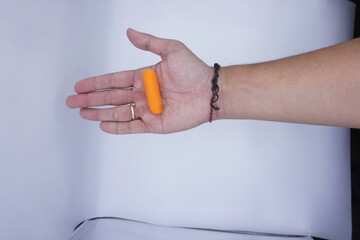 Hand holding baby carrot stock photo