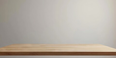 A wooden desk positioned in front of a clean, white wall serves as a backdrop for showcasing products and creating promotional material effectively.