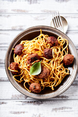 Spaghetti Pasta with Meatballs and fresh Basil o bright background. Close up.
