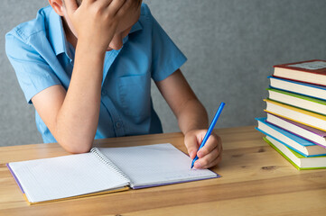 Frustrated Student with Books Studying for Exams. International Left Handers Awareness Day