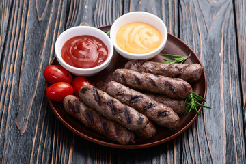 Grilled beef sausages with rosemary sauce and tomatoes photography . Top view