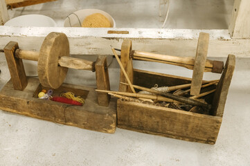 Traditional wool spinning tools and yarn display in rustic workshop setting