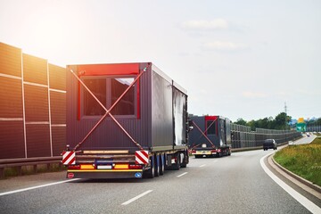 Prefabricated buildings on trailers heading down highway