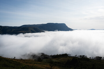 Mountain peak sticking out of a fog bank