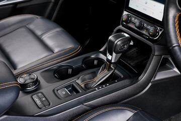 automatic transmission shift selector in the car interior. Closeup a manual shift of modern car gear shifter. 4x4 gear shift
