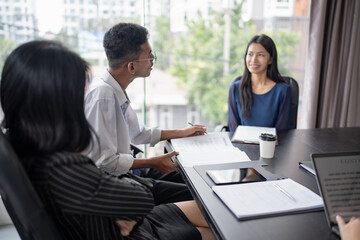 Examiner reading a resume during job interview at office Business and human resources concept.