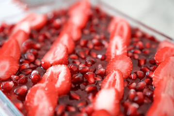 Tasty cake with fresh strawberries and mint isolated on white Red velvet cake with fresh strawberries. Festive layered cake from red sponge cakes and cream cheese frosting.