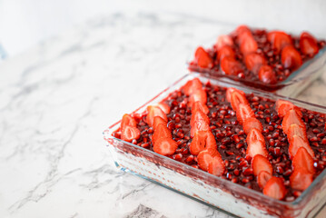 Tasty cake with fresh strawberries and mint isolated on white Red velvet cake with fresh strawberries. Festive layered cake from red sponge cakes and cream cheese frosting.
