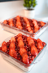 Tasty cake with fresh strawberries and mint isolated on white Red velvet cake with fresh strawberries. Festive layered cake from red sponge cakes and cream cheese frosting.