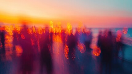 Vibrant abstract blur of a crowd celebrating at a beach sunset party featuring dynamic bokeh effects