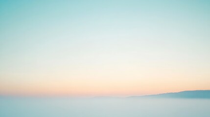 Fototapeta premium A stunning sunrise over the mountains, creating a soft and dreamy backdrop.