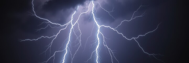 A bright lightning bolt strikes through the dark sky during a summer thunderstorm