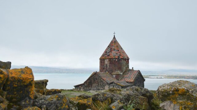 Timelapse zoom out Sevanavank monastic complex building with Sevan lake. Peninsula at the northwestern shore of Lake Sevan in the Gegharkunik Province of Armenia. Popular travel sightseeing attraction