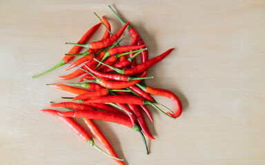 Red Hot Chili Peppers in wooden background, Overhead view of chili pepper on wood background