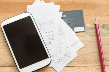 mobile phone ,slips of credit card for business work of lifestyle on background wooden