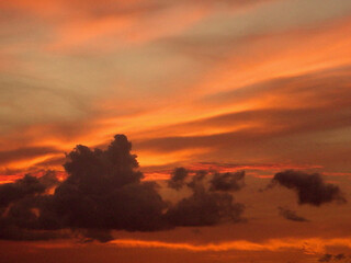 Gorgeous sunset with beautiful colors, clouds and silhouettes, at the end of a warm summer day.