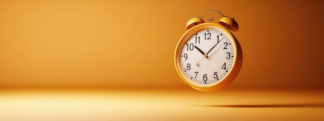 A yellow clock with the hands at the numbers 3 and 9