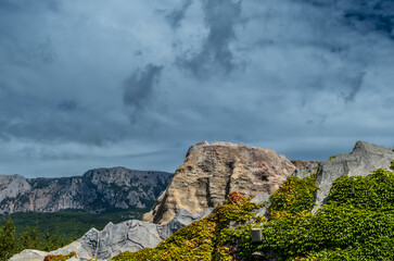 Rocky mountains on a background of clouds on a summer day.